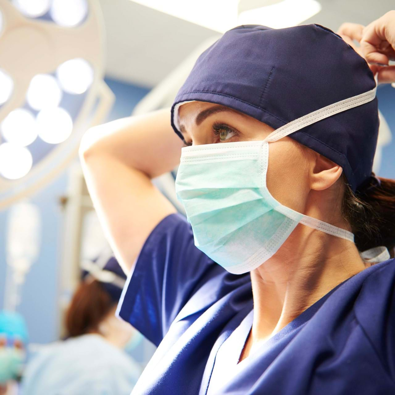 Medical professional putting on mask