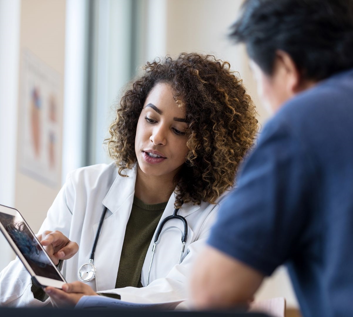 Doctor showing patient information on a tablet